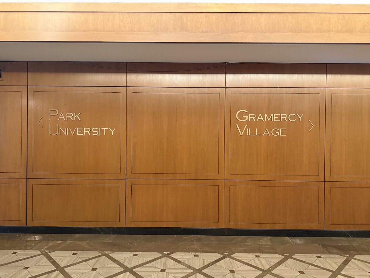 Wood-panelled signs on the 7th floor pointing left to Park and University, right to Gramercy and Village