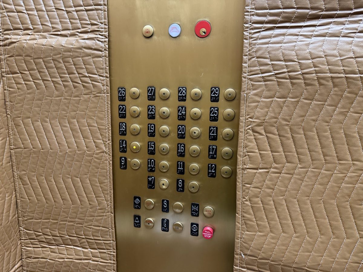 The Village Tower elevator panel, with the button for 14 lit