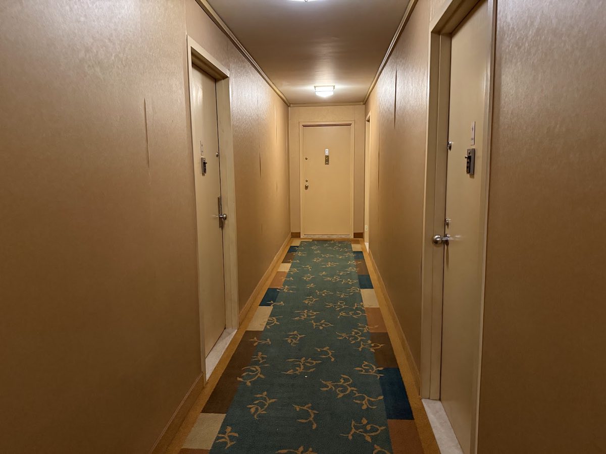 A narrow hallway on the 14th floor, with our apartment the last door on the left