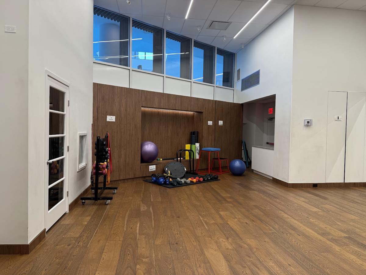 The room to the right of the gym entrance, with the playroom door on the left